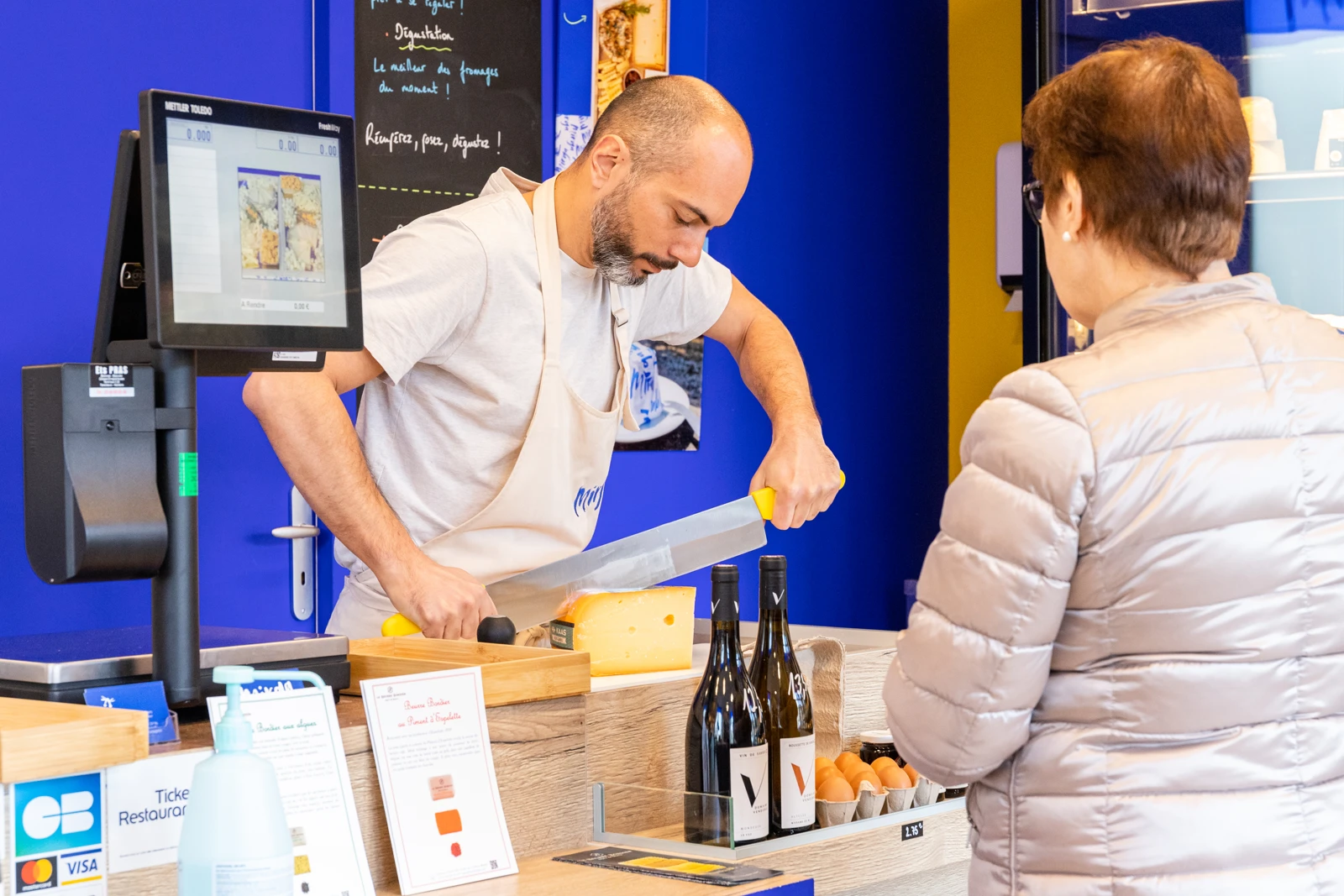 Un fromage découpé chez Mirga, pendant un échange avec une cliente